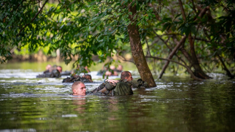 Militaire dérivant dans l'eau avec son sac.
