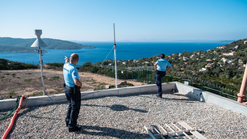 Sur le toit d'une antenne, deux gendarmes regardent la partie habitée de l'ile.