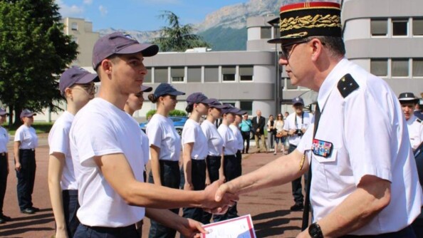 Un cadet reçoit son brevet des mains d'un général de brigade.
