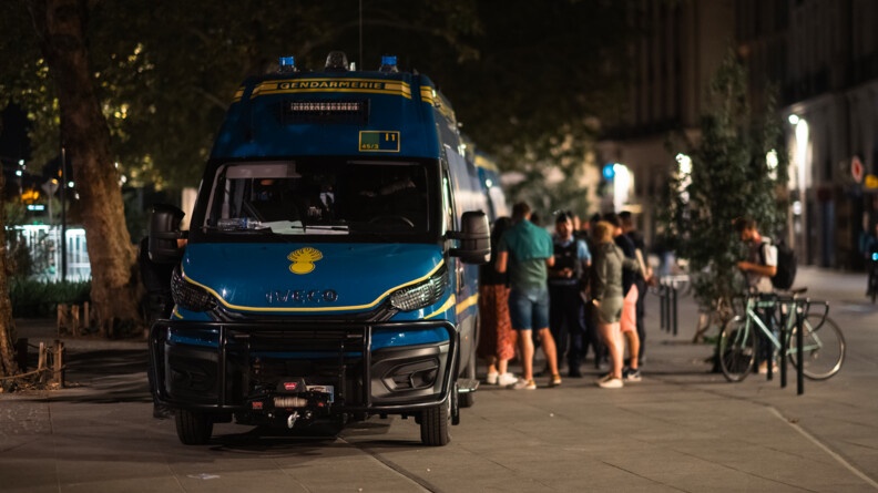 Vue de face d'un véhicule de maintien de l'ordre en ville de nuit