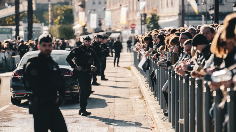 Gendarmes mobiles alignés devant la foule en sécurisation du passage du pape.
