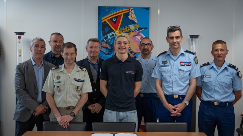 A droite trois gendarmes en tenu d'état-major, au centre un jeune sportif de haut-niveau de la gendarmerie nationale, à sa gauche un commanadnt de l'armée de terre et trois civils posent pour une photo de groupe derrière une table