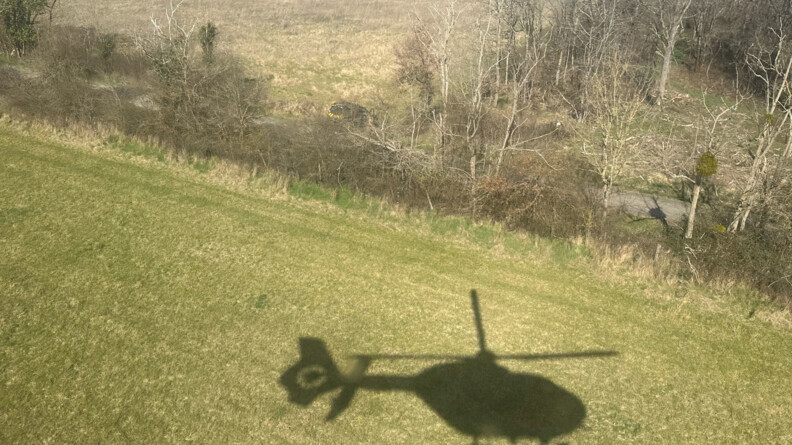 Ombre d'un h&eacute;licopt&egrave;re devant une zone bois&eacute;e