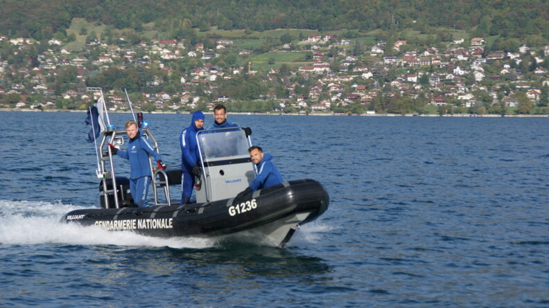 Quatres gendarmes, grand sourire aux lèvres, posent à bord de leur vedette.