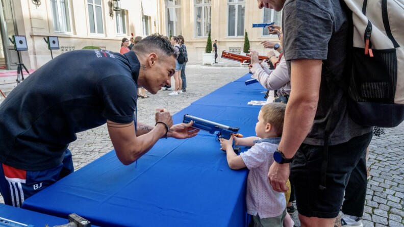 Agrandir l'image Un enfant s'essaye au tir avec le pentathlète Christopher Patte, sportif de haut niveau de la Défense - gendarmerie.