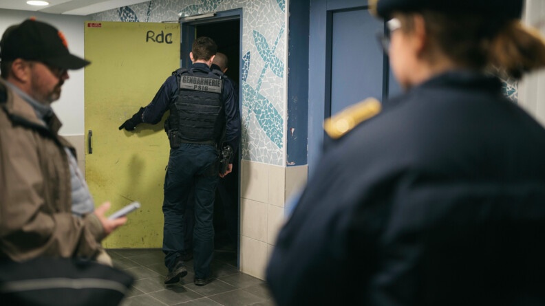 Deux gendarmes au sous ol pour une fouille avec la préfète