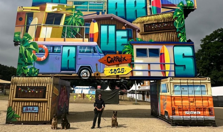 Agrandir l'image Un maître de chien et trois chiens sous une structure des vieilles charrues.