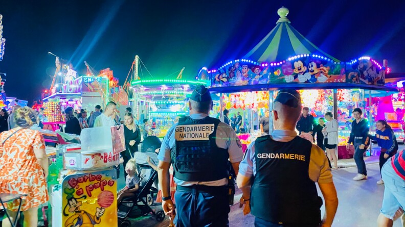 Agrandir l'image Au coeur d'une fête foraine, deux gendarmes réalisent une patrouille de nuit.