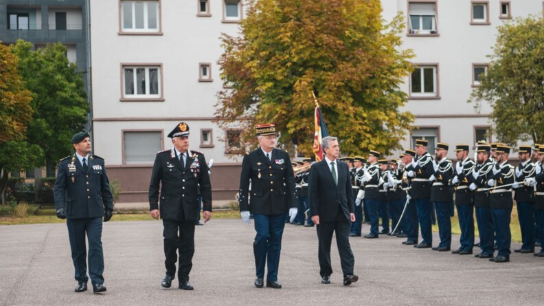 Trois chefs de police dont le directeur général de la gendarmerie nationale effctuent la revue des troupes. A droite, les troupes: des gendarmes mobiles en tenue de cérémonie présenant les armes