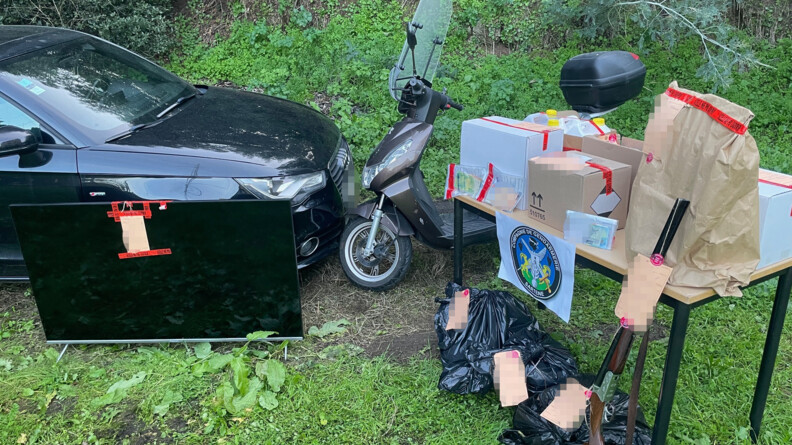 Une audi noire, un scooter, un écran plat, et sur une table des scellés avec le logo de la compagnie de gendarmerie de Sartène, sur de l'herbe