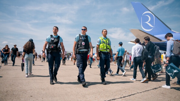 Trois gendarmes de la GTA, dont n avec une chasuble jaune, patrouille au milieu des visiteurs du Salon du Bourget