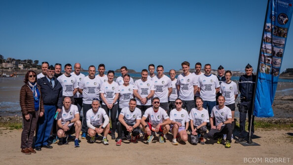 Photo d'un groupe de gendarmes au départ d'une course, vêtus du même tshirt blanc. Certains sont accroupis, d'autres debout, se tenant devant une plage.