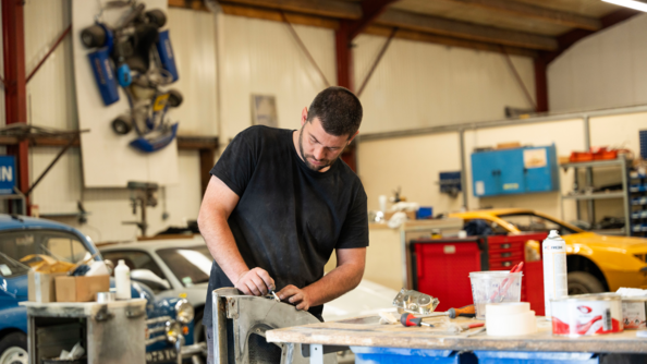 Le mécanicien travaille une pièce de l'Alpine A110 dans l'atelier du garage meca retro sport 76