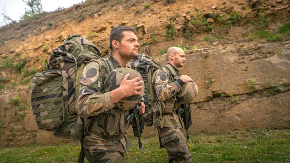 2 élèves officiers se dirigent vers un autre exercice, avec tout leur paquetage