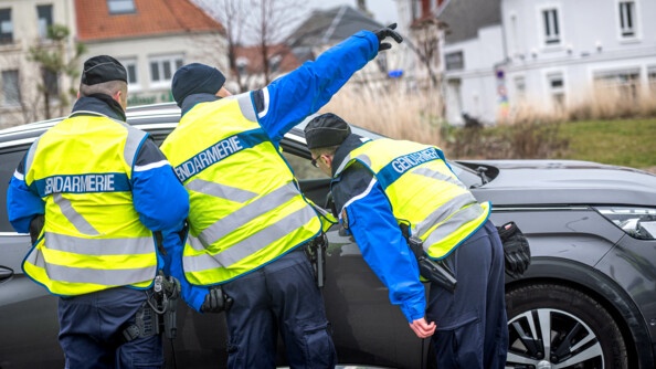 Photos de trois réservistes s'occupant de la gestion des flux, de dos indiquant le chemin à une voiture.