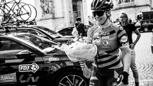 La garde Derbesse tenant un bouquet de fleurs apr&egrave;s une comp&eacute;tition de v&eacute;lo.