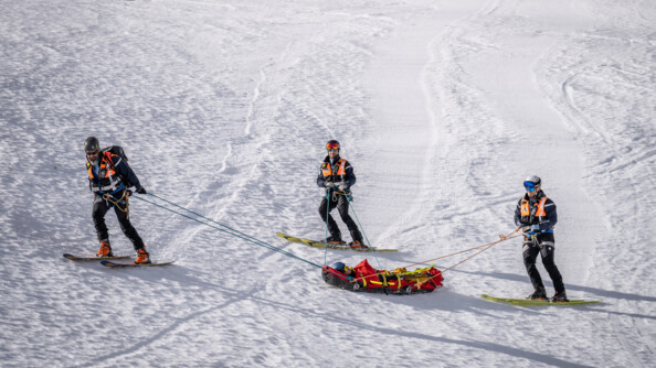 Les trois gendarmes et la victime descendent en ski.