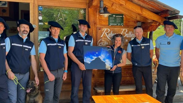 Les gendarmes du PGHM et Nils Allegre sont alignés devant la façade du refuge.
