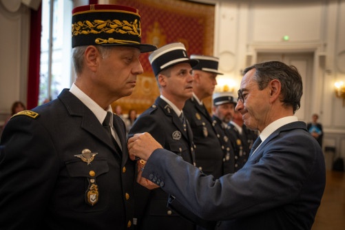 Le ministre de l'Intérieur, Bruno Retailleau, décore un gendarme de la médaille du Mérite.