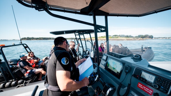 Contrôle en mer d'une embarcation à moteur par la brigade nautique de Quiberon. Le gendarme vérifie les papiers du bateau.